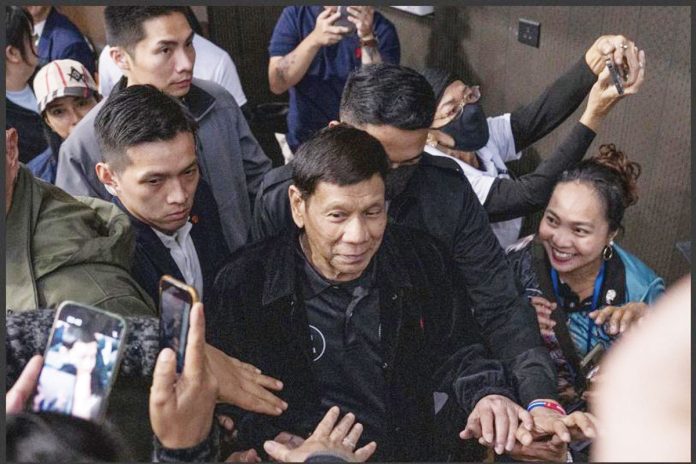 Former president Rodrigo Duterte arrives inside the Southorn Stadium during a thanksgiving gathering organized by Hong Kong-based Filipino workers for the former populist president in Hong Kong on Sunday, March 9. The following day upon his return to Manila, Duterte was arrested upon the order of the International Criminal Court for the charge of “crimes against humanity”. AP