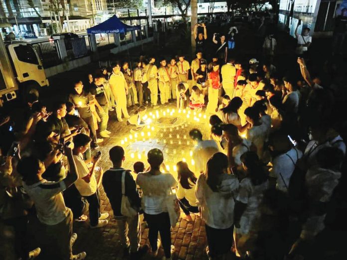 The Iloilo Provincial Government spearheads “Ligum-Dulom”, an Earth Hour observance, at the capitol lobby on March 22 from 8:30 p.m. to 9:30 p.m. Photo shows participants lighting candles in the shape of the Earth Hour symbol at the capitol ground in March last year. EMB 6 PHOTO