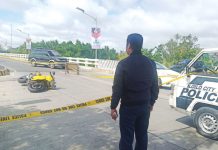 A police officer secures the spot where motorcycle-driving businessman Delfin Britanico was shot to death in Barangay Nabitasan, La Paz, Iloilo City on Jan. 19. 2020. PN FILE