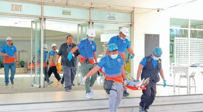 Rescue teams carry out an emergency evacuation during an earthquake drill at the Iloilo Provincial Capitol, testing the effectiveness of response operations. Photo by Dharlyn Mae Qubing, Intern, University of Antique