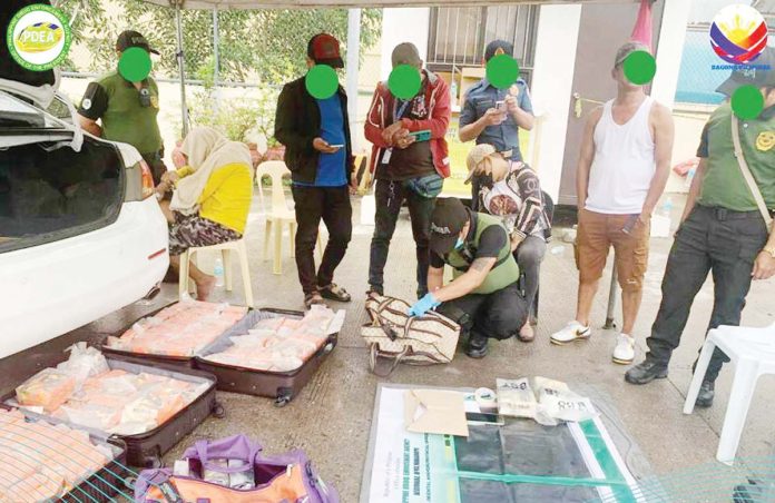 Personnel of the Philippine Coast Guard and Philippine Drug Enfor cement Agency discover shabu concealed in traveling bags at the Calapan Port in Mindoro. PDEA REGIONAL OFFICE MIMATIPA FB PHOTO