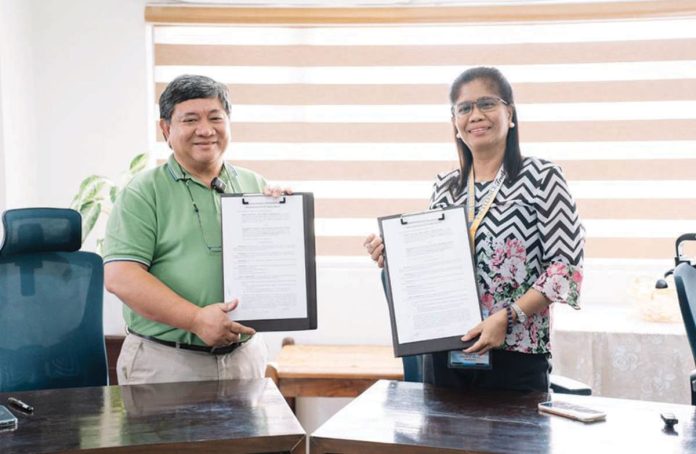 MORE Power president and chief executive officer Roel Z. Castro and Philippine Science High School - Western Visayas campus director Dr. Myrna Libutaque formalize a partnership to establish a seedling nursery at the school’s Barangay Bito-on campus in Jaro, Iloilo City through a memorandum of agreement.