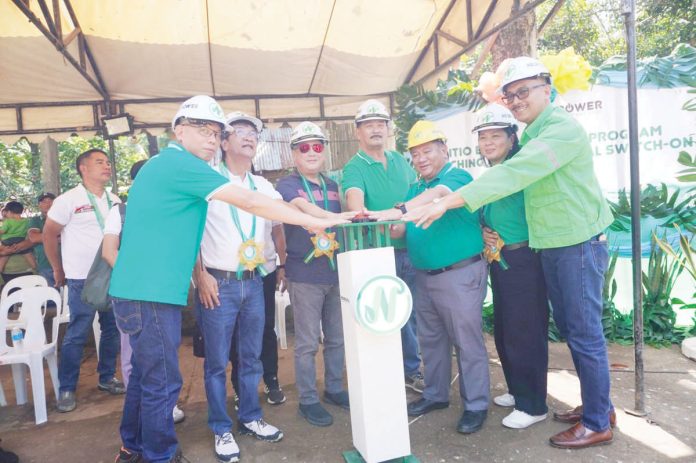 (From left) Sitio Electrification Program Project Manager Engr. Leomel Tambanillo; Bago City’s Vice Mayor Ramon Torres and Mayor Nicholas Yulo; Punong Barangay Remy Jalea of Binubuhan; and Negros Power’s President Roel Castro, VP for Customer Care Maricel Pe and COO Engr. Bailey Del Castillo. NEPC PHOTO