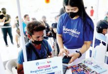 The National Telecommunications Commission is looking into requiring personal appearance for SIM card registration. Photo shows a staff member of a telecommunications firm helping a client register his SIM card. PNA PHOTO BY BEN BRIONES