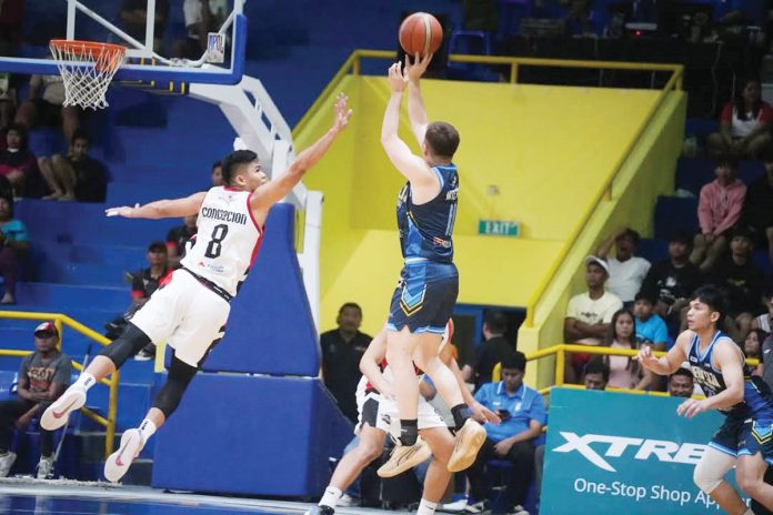 Basilan Viva Portmasters’ Sherwin Concepcion tries to defend the shot of Nueva Ecija Rice Vanguards’ John Wilson. MPBL PHOTO