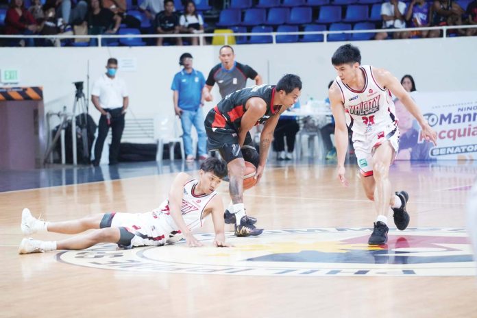 Basilan Viva Portmasters’ Gab Dagangon picks the ball away from a Valenzuela Classic Dynacast player. MPBL PHOTO