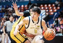 Ilonggo Chad Cartel of the National University Nazareth School Bullpups tries to ward off a University of Santo Tomas Tiger Cubs' defender. UAAP PHOTO