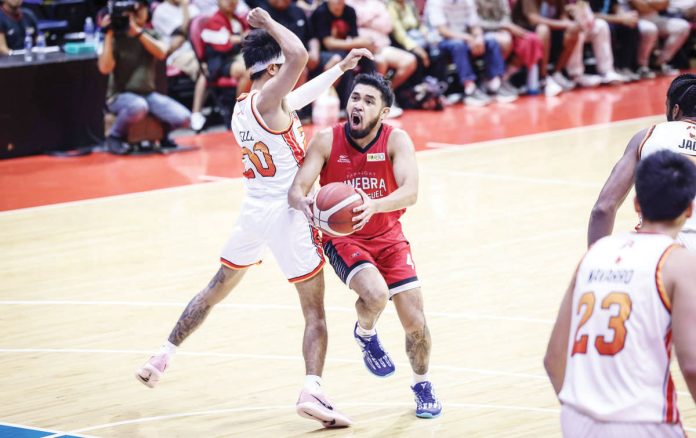 Barangay Ginebra San Miguel Kings’ Rhon Jay Abarrientos tries to score against the defense of NorthPort Batang Pier’s Evan Nelle. PBA PHOTO