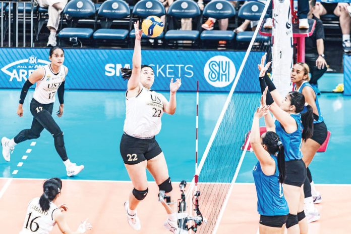 University of Santo Tomas Golden Tigresses’ Bianca Plaza attempts a drop ball against the defense of Ateneo de Manila University Blue Eagles. UAAP PHOTO